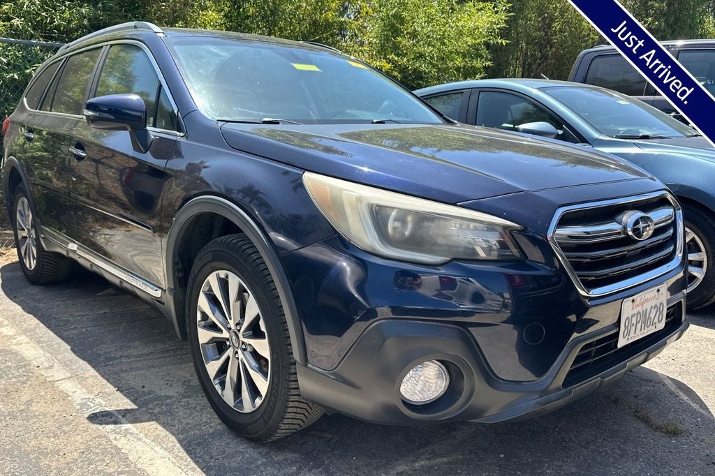 2018 Subaru Outback 3.6R Touring in Dark Blue Pearl — front three-quarter view